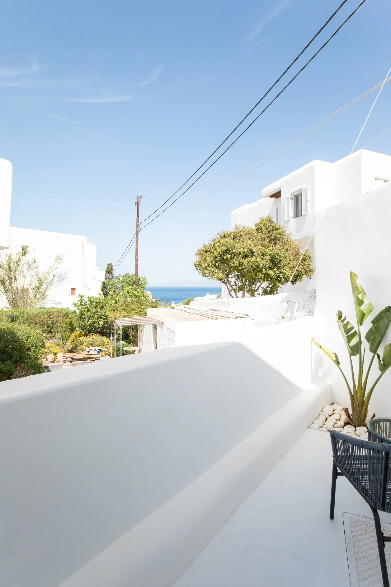 Terrace with a glimpse of the sea and the rooftops of Mykonos Town